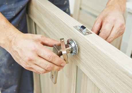 Image showing a joinery fitting a set of door handles on a rose to a door