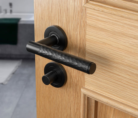 Image showing a door handle on a round rose and a bathroom turn in matt black