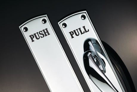 Image showing a Finger Plate in polished chrome from Carlsile Brass with the word "Push" on it and a pull handle with the word "pull" on it