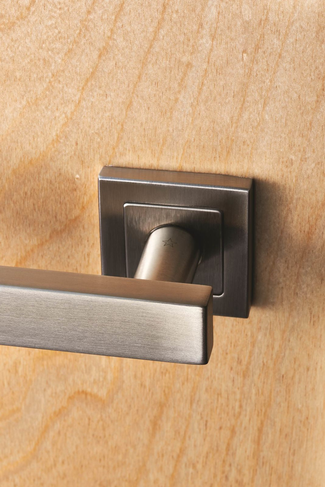 Image showing a EuroSpec Door Handle on a square rose in satin stainless steel.  Available to order from Trade Door Handles, Kendal