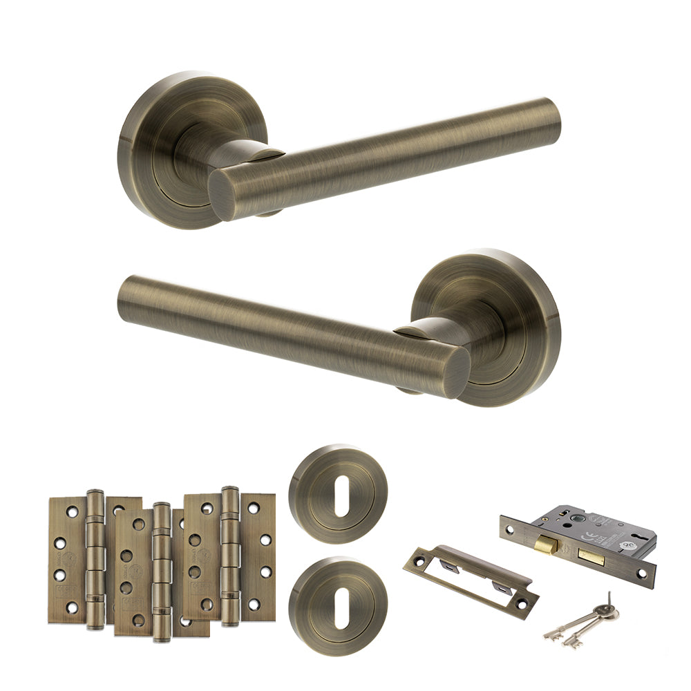 Quality image of STATUS Nebraska Door Handle Pack (3 Lever Lock Set - 3" CE Sashlock, 4" Fire Rated Hinges x3) - Antique Brass | Sku. adps28rab17 | available from Trade Door Handles.