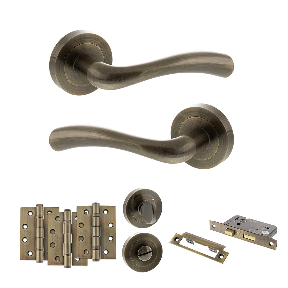 Quality image of STATUS Texas Door Handle Pack (Bathroom Set - 3" CE Bathroom Lock, 4" Fire Rated Hinges x3) - Antique Brass | Sku. adps35rab11 | available from Trade Door Handles.