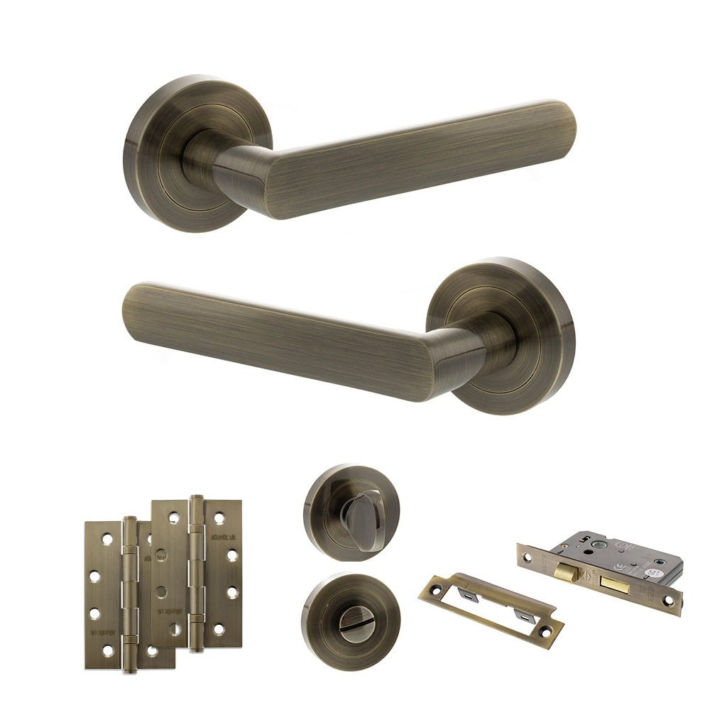 Quality image of STATUS Carolina Door Handle Pack (Bathroom Set - 3" CE Bathroom Lock, 4" Slim Knuckle Hinges x2) - Antique Brass | Sku. adps42rab13 | available from Trade Door Handles.