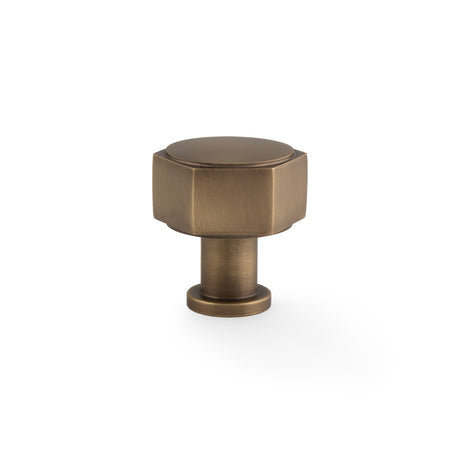 This is an image showing Alexander & Wilks - Vesper Hex Cabinet Knob - Antique Brass aw828-33-ab available to order from Trade Door Handles in Kendal, quick delivery and discounted prices.
