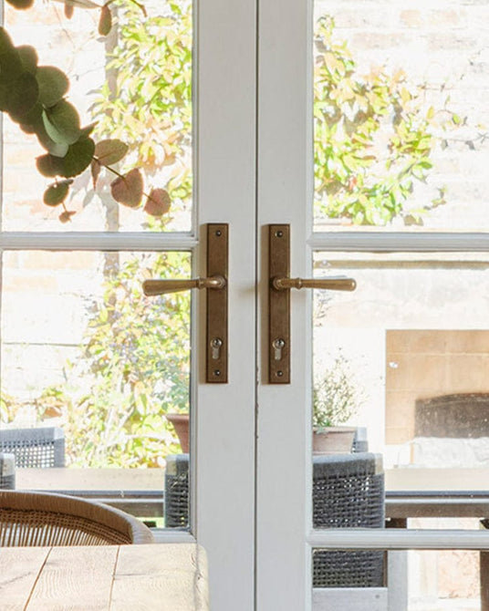 This is a image of From The Anvil Aged Brass Newbury Slimline Lever Espag. Lock Set Handles