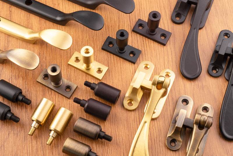 Image showing  range of casement window hardware from Carlisle Brass including Casement Stays, Fasteners and locking pins in a range of finishes including satin brass, antique brass and matt black