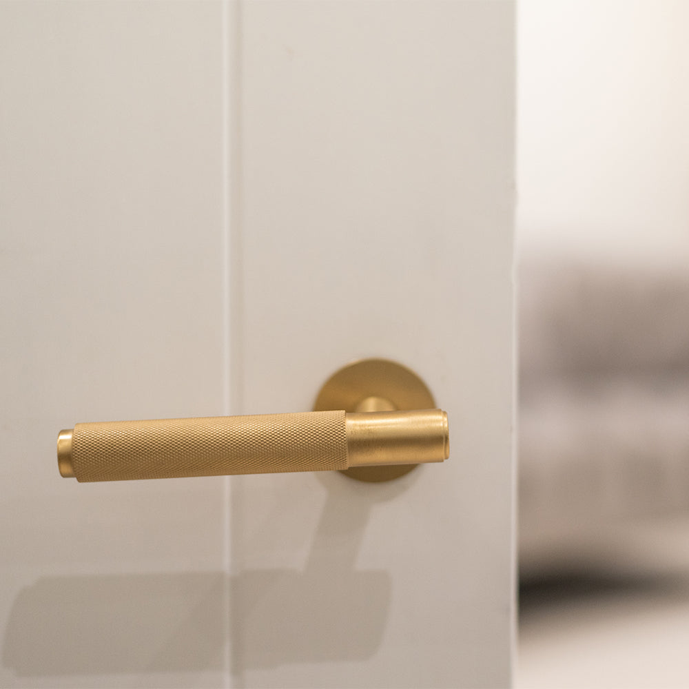 Quality image of Millhouse Brass Crompton Knurled Lever Door Handle on 5mm Slimline Round Rose - Satin Brass | Sku. mhsr100sb | available from Trade Door Handles.