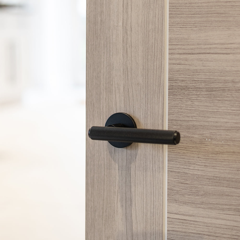 Quality image of Millhouse Brass Stephenson Knurled Lever Door Handle on 5mm Slimline Round Rose - Matt Black | Sku. mhsr250mb | available from Trade Door Handles.
