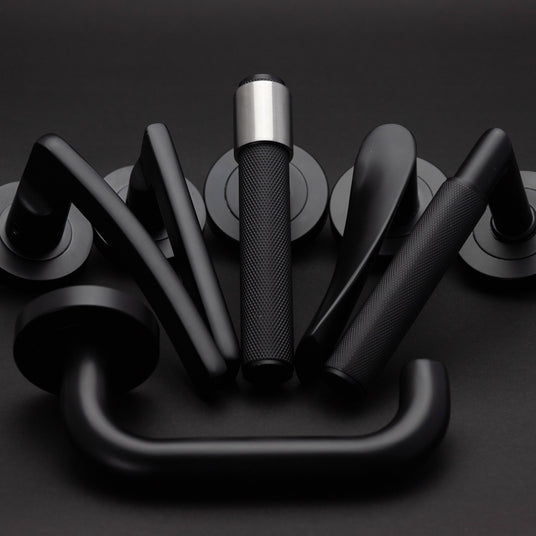 Image showing a collection of door furniture by Frelan Hardware in a modern matt black finish.  Available to order from Trade Door Handles in Kendal