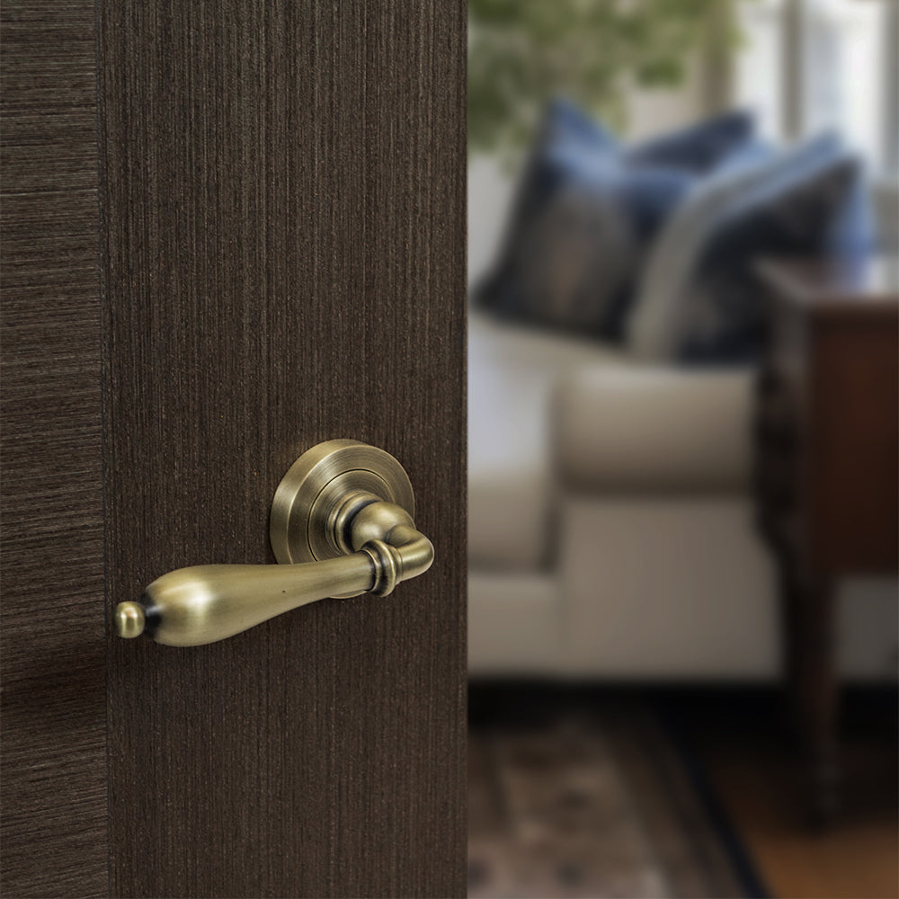 Quality image of Old English Wrexham Lever Door Handle on Round Rose - Matt Antique Brass | Sku. oe142mab | available from Trade Door Handles.