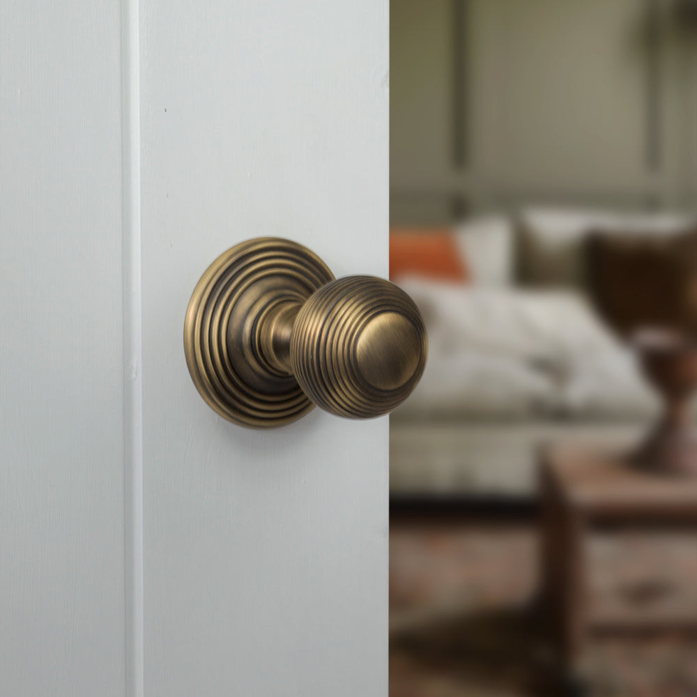 Quality image of Old English Ripon Solid Brass Reeded Mortice Knob on Concealed Fix Rose - Antique Brass | Sku. oe50rmkab | available from Trade Door Handles.