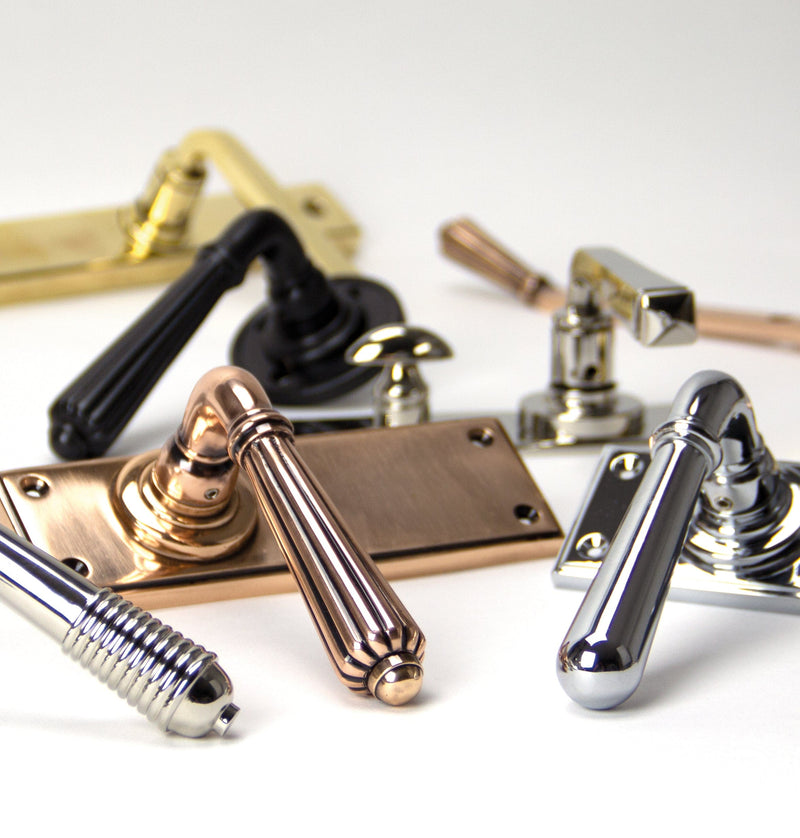 Image showing a range of From The Anvil Period Lever Handles in various finishes. Available to order from Trade Door Handles in Kendal