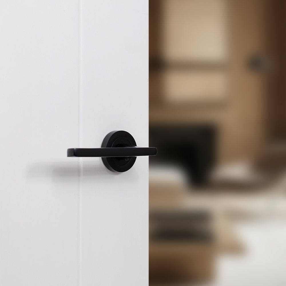 Quality image of STATUS Alaska Lever Door Handle on Round Rose - Matt Black | Sku. s26rmb | available from Trade Door Handles.