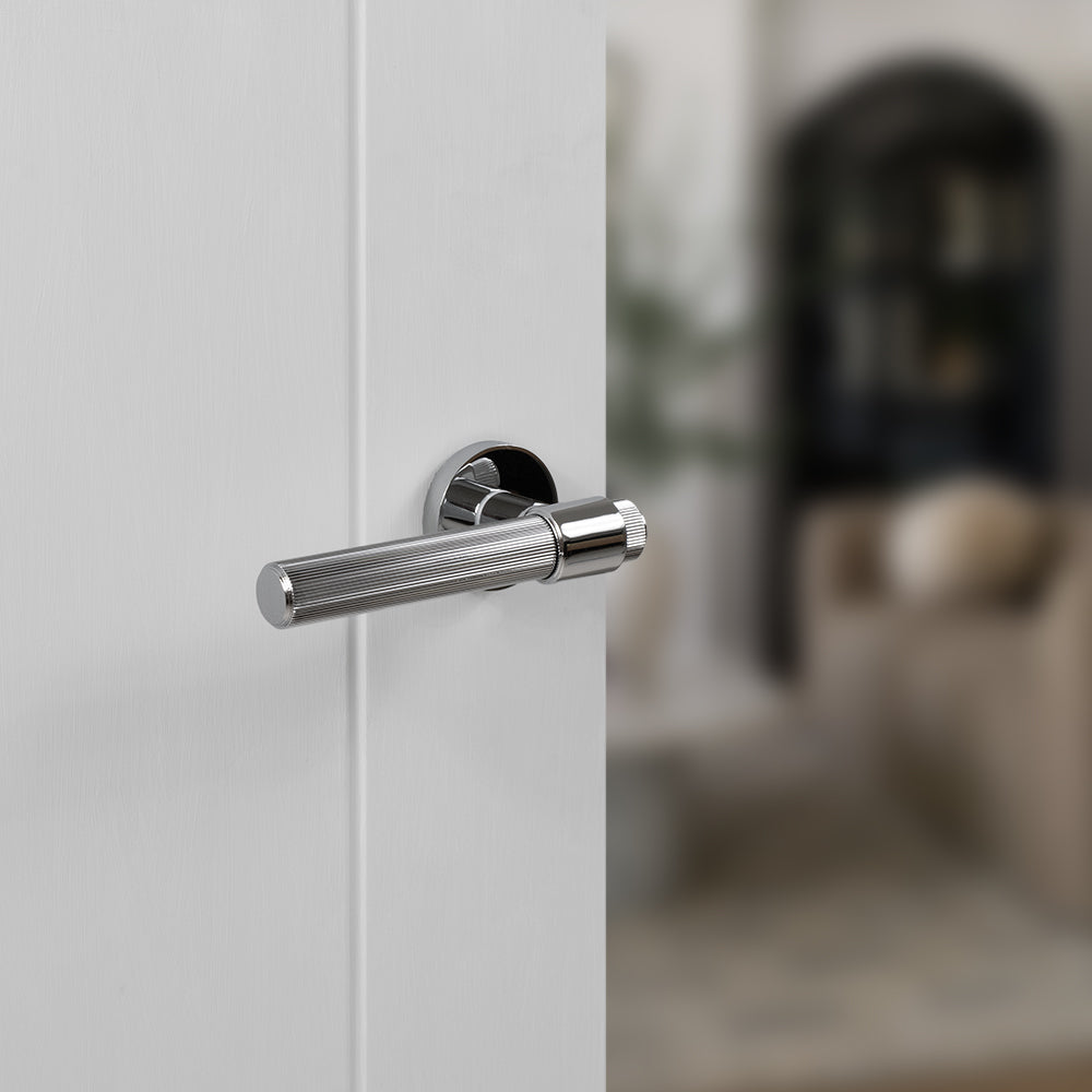 Quality image of Senza Pari Fasana Linear Knurled Lever Door Handle on Minimal Round Rose - Polished Chrome | Sku. spr165pc | available from Trade Door Handles.
