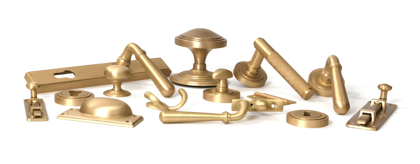 Image showing a range of Door Handles, Window Fittings and Cabinet Hardware in Satin Brass by From The Anvil.  Available to order from Trade Door Handles in Kendal