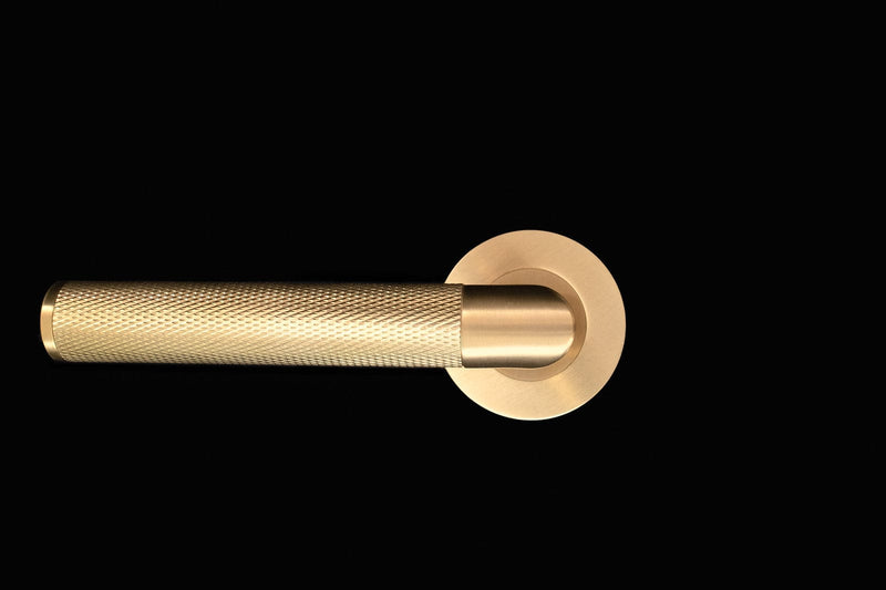 Satin Brass Door Handles on Rose by Alexander and Wilks