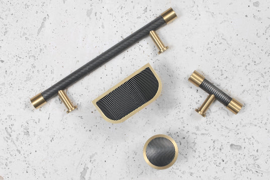 Image showing a range of Immix Spiral Antique Gold Kitchen and cabinet hardware. Available to order from Trade Door Handles