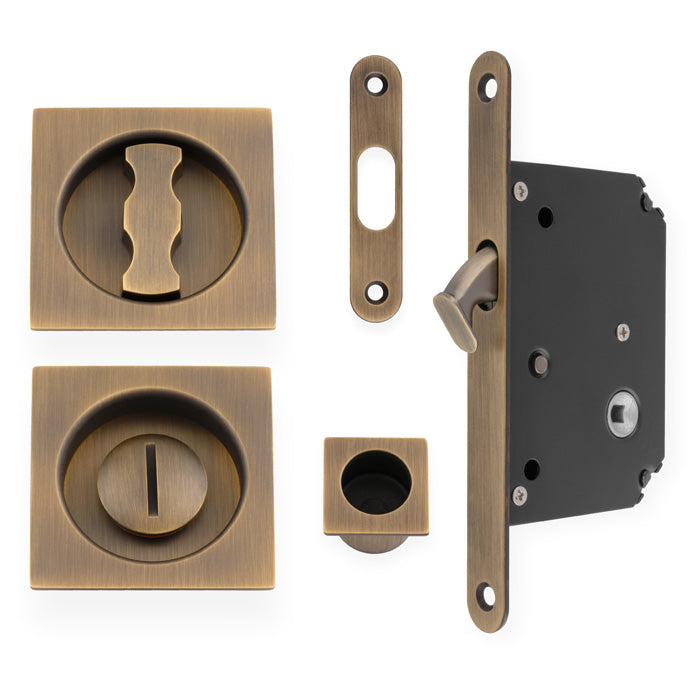 High quality image of Alexander & Wilks - Sliding Door Lock Set - Square Roses - Radius Forend & Strike-Antique Brass | Sku. aw111rab | Trade Door Handles.