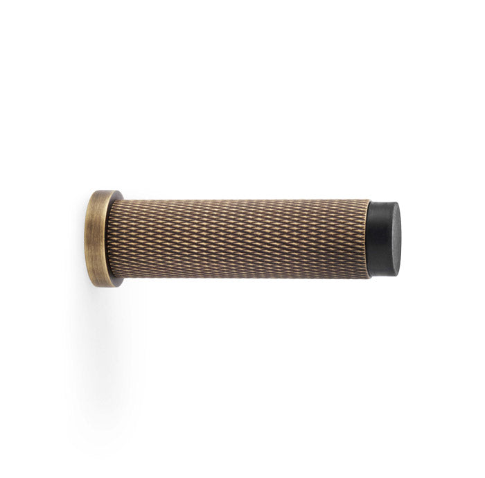 High quality image of Alexander & Wilks - Brunel Knurled Door Stop - Antique Brass | Sku. aw600-75-ab | Trade Door Handles.