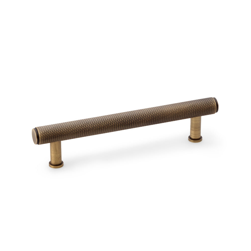 High quality image of Alexander & Wilks Crispin Knurled T-bar Cupboard Pull Handle - Antique Brass - Centres 128mm | Sku. aw809-128-ab | Trade Door Handles.