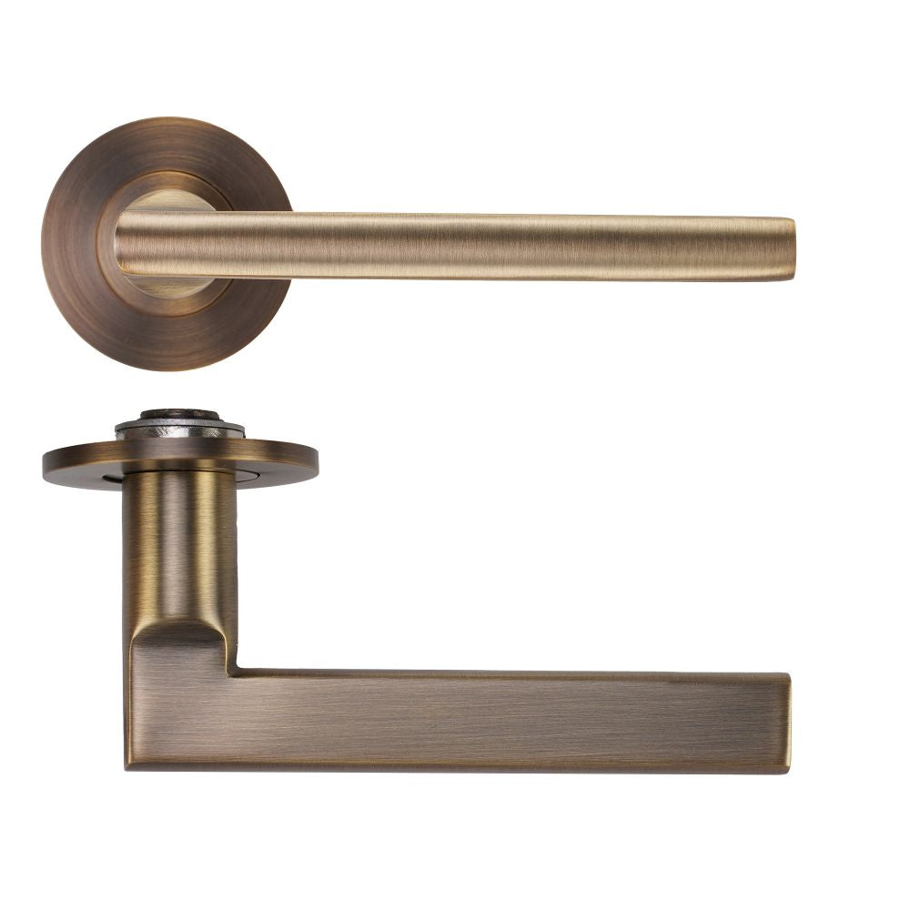 High quality image of the Rosso Tecnica - Varese Lever on 4mm Round Slim Sprung Rose - Antique Brass | Sku. RT040-SLIM-AB | available to order from Trade Door Handles.