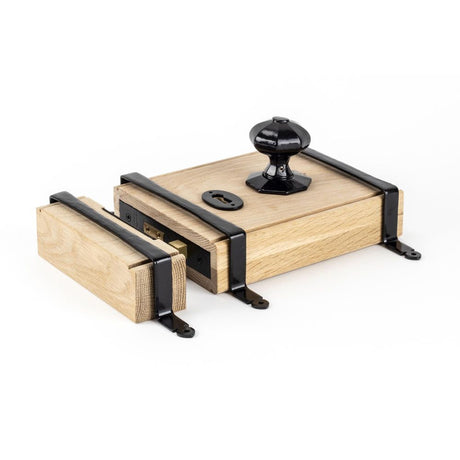 This is an image showing From The Anvil - Black Oak Box Lock & Octagonal Knob Set available from trade door handles, quick delivery and discounted prices