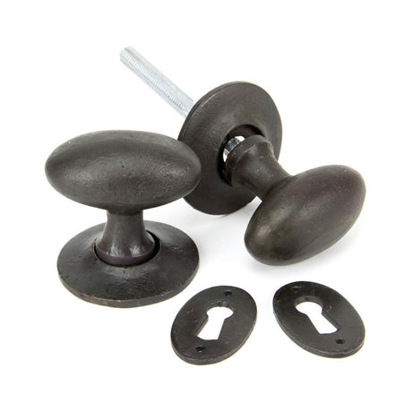 This is an image showing From The Anvil - Beeswax Oval Mortice/Rim Knob Set available from trade door handles, quick delivery and discounted prices