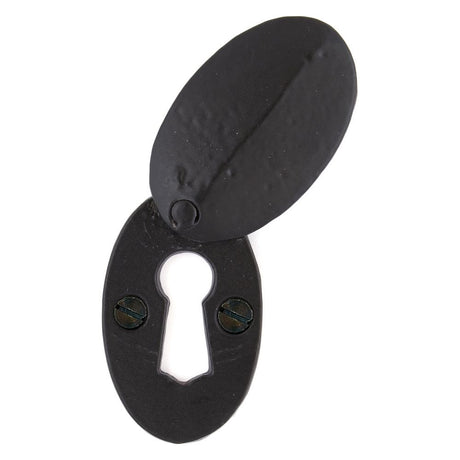 This is an image showing From The Anvil - Black Oval Escutcheon & Cover available from trade door handles, quick delivery and discounted prices