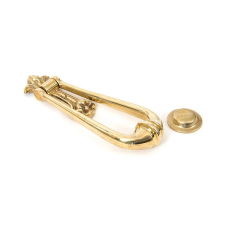 This is an image showing From The Anvil - Polished Brass Loop Door Knocker available from trade door handles, quick delivery and discounted prices