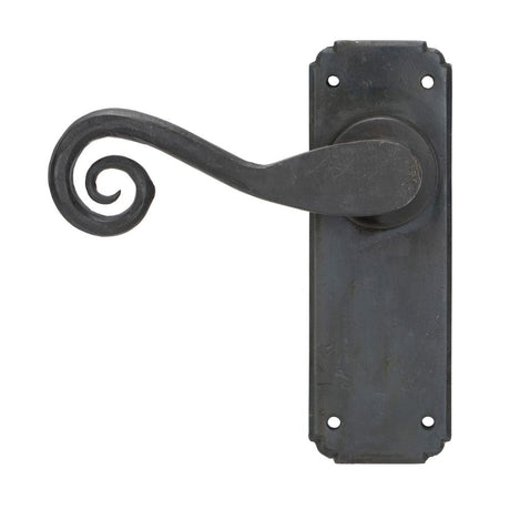 This is an image showing From The Anvil - Beeswax Monkeytail Lever Latch Set available from trade door handles, quick delivery and discounted prices