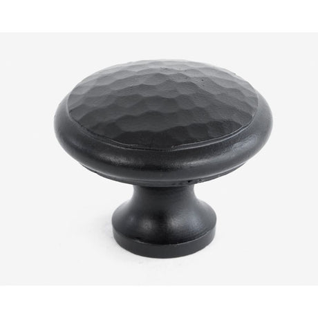 This is an image showing From The Anvil - Black Hammered Cabinet Knob - Large available from trade door handles, quick delivery and discounted prices