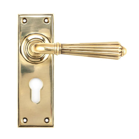 This is an image showing From The Anvil - Aged Brass Hinton Lever Euro Lock Set available from trade door handles, quick delivery and discounted prices