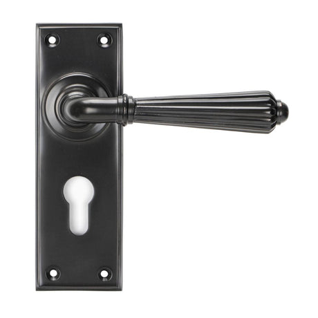 This is an image showing From The Anvil - Aged Bronze Hinton Lever Euro Lock Set available from trade door handles, quick delivery and discounted prices