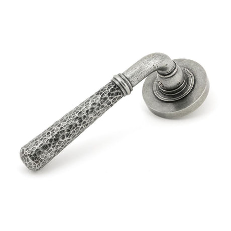 This is an image showing From The Anvil - Pewter Hammered Newbury Lever on Rose Set (Plain) available from trade door handles, quick delivery and discounted prices