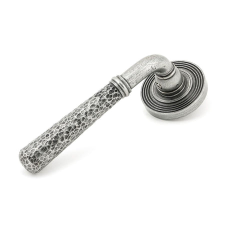 This is an image showing From The Anvil - Pewter Hammered Newbury Lever on Rose Set (Beehive) available from trade door handles, quick delivery and discounted prices