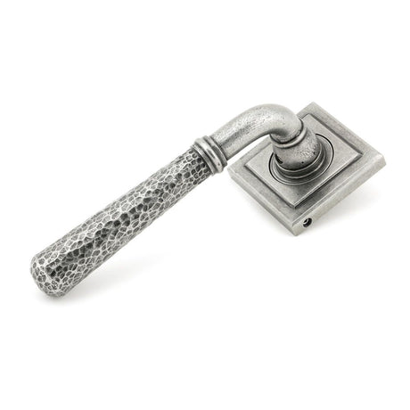 This is an image showing From The Anvil - Pewter Hammered Newbury Lever on Rose Set (Square) available from trade door handles, quick delivery and discounted prices