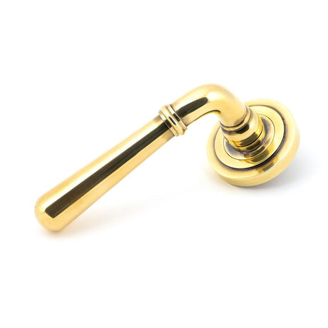 This is an image showing From The Anvil - Aged Brass Newbury Lever on Rose Set (Art Deco) available from trade door handles, quick delivery and discounted prices