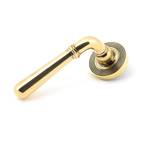 This is an image showing From The Anvil - Aged Brass Newbury Lever on Rose Set (Beehive) available from trade door handles, quick delivery and discounted prices