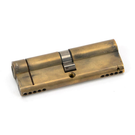This is an image showing From The Anvil - Aged Brass 45/45 5pin Euro Cylinder available from trade door handles, quick delivery and discounted prices