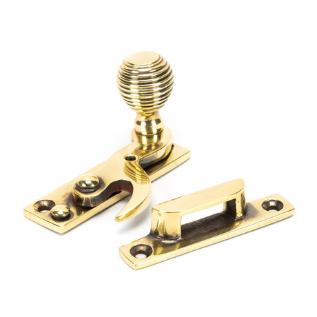 This is an image showing From The Anvil - Aged Brass Beehive Sash Hook Fastener available from trade door handles, quick delivery and discounted prices
