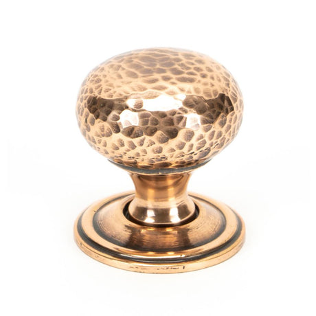 This is an image showing From The Anvil - Polished Bronze Hammered Mushroom Cabinet Knob 32mm available from trade door handles, quick delivery and discounted prices