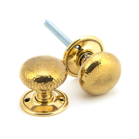 This is an image showing From The Anvil - Aged Brass Hammered Mushroom Mortice/Rim Knob Set available from trade door handles, quick delivery and discounted prices