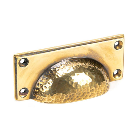 This is an image showing From The Anvil - Aged Brass Hammered Art Deco Drawer Pull available from trade door handles, quick delivery and discounted prices
