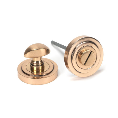 This is an image showing From The Anvil - Polished Bronze Round Thumbturn Set (Art Deco) available from trade door handles, quick delivery and discounted prices