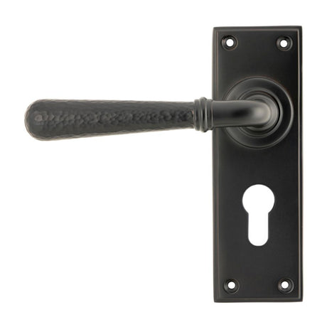 This is an image showing From The Anvil - Aged Bronze Hammered Newbury Lever Euro Lock Set available from trade door handles, quick delivery and discounted prices