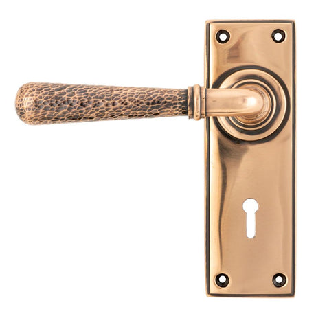 This is an image showing From The Anvil - Polished Bronze Hammered Newbury Lever Lock Set available from trade door handles, quick delivery and discounted prices