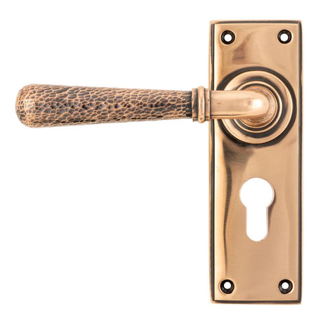 This is an image showing From The Anvil - Polished Bronze Hammered Newbury Lever Euro Lock Set available from trade door handles, quick delivery and discounted prices