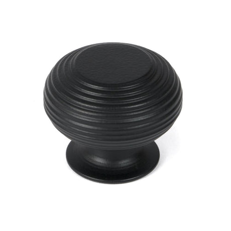 This is an image showing From The Anvil - Matt Black Beehive Cabinet Knob 40mm available from trade door handles, quick delivery and discounted prices