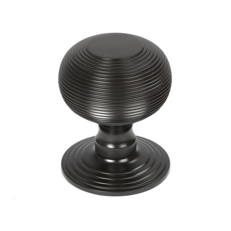 This is an image showing From The Anvil - Aged Bronze Beehive Centre Door Knob available from trade door handles, quick delivery and discounted prices