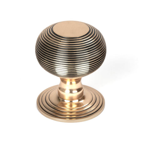 This is an image showing From The Anvil - Polished Bronze Beehive Centre Door Knob available from trade door handles, quick delivery and discounted prices